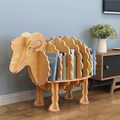 an animal shaped book shelf with books on it