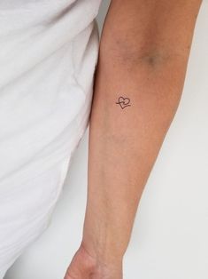 a person with a heart tattoo on their arm