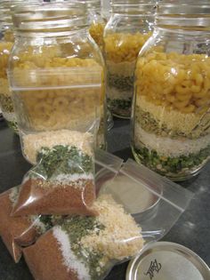 several jars filled with food sitting on top of a counter next to other containers full of food