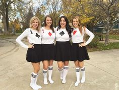 three girls dressed in black and white are posing for the camera with their hands on their hips