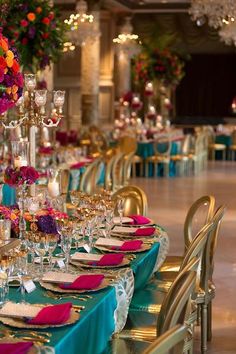 the tables are set up with colorful flowers and place settings for dinner or wedding guests