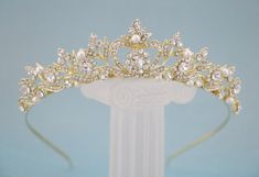 "Gold Bridal Tiara, Wedding Tiara, Gold Bridal Crown, Gold Leaf Crown, Rhinestone Crown, Bride Tiara, Gold Tiara This elegant and sparkle rhinestone Tiaras is perfect for your wedding or formal night out. This Tiaras is flexible. It will be perfect for the bride. The Metal Headband measured approx. 14\" long. The rhinestone part of the headband is about 7.25\" long and the center is 1.5\" high. Tone color: Silver tone, Gold tone and Rose gold tone. Pearl color : Swarovski white pearl and Ivory p Simple Tiara, Gold Bridal Tiara, Gold Leaf Crown, Gold Bridal Crowns, Crown Bride, Tiara Gold, Rose Gold Tiara, Crown Silver, Pearl Bridal Headband