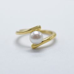 our Smooth Operator ring features a sleek design offering a modern, glamorous look with timeless sophistication. designed in 18k gold over stainless steel, for long-lasting, daily wear. accented by a freshwater pearl, it is the perfect accessory for any occasion, day or night. 18kt gold pvd over stainless steel 6mm freshwater pearl band is 2mm thick Modern Pearl Ring, Ring Pearl Modern, Gem Art, Pearl Engagement Ring, Synthetic Diamond, Gold Bond, Gems Art, Smooth Operator, Midi Ring