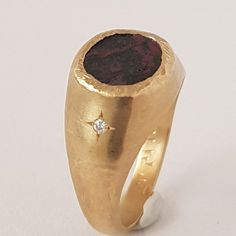 Organic form meets expert craftsmanship with this stunning 18K solid gold ring. A signet ring set with a Jewish coin from the Bar Kochba period. The currency is called "rays of abundance." Inlaid with two 1mm white diamonds on the side of the ring.You can add engraving on the coin- letter, name, or symbol.Each ring is handcrafted and one of a kind, just like the singular union they represent.◈ DETAILS✧Weight: 6g✧Ring width at the bottom: 3mm / 0.12''✧Coin length: 9.5mm / 0.37''✧Coin width - 8.5m Unique Engraved Yellow Gold Signet Ring, Engraved Yellow Gold Signet Ring, Luxury Yellow Gold Signet Ring, Unique Yellow Gold Hallmarked Signet Ring, Unique Yellow Gold Signet Ring Hallmarked, Fine Jewelry Signet Ring With Intaglio As Gift, Hallmarked Yellow Gold Signet Ring, Unique Ceremonial Signet Ring, Luxury Gold Ruby Ring With Single Cut Diamonds