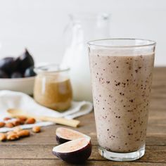 there is a glass with some food in it next to other foods on the table