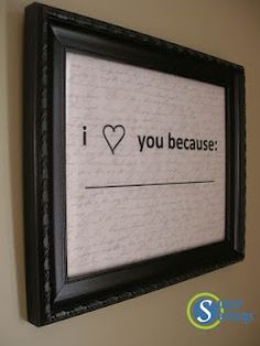 a black frame hanging on the wall with an i love you message