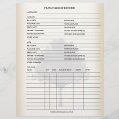 the family group record is shown on top of a marble table with a white background