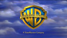 the logo for warner bros pictures is shown in front of a blue sky with clouds