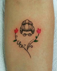 a woman's leg with a tattoo on it that has flowers and an image of a lady