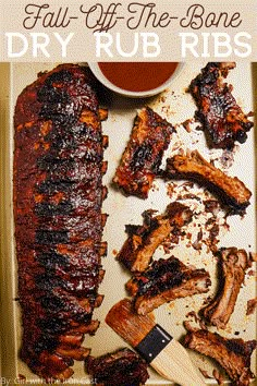 barbecue ribs and bbq sauce on a tray with text overlay that reads, fall off the bone dry rub ribs