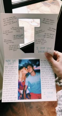 a person holding up an i love you card with the letter t on it and two photos attached to it