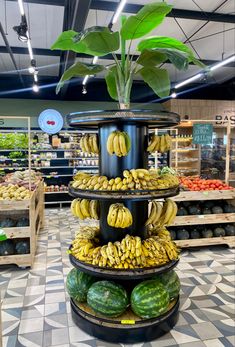 there are many bananas and watermelons in the produce section of this store,