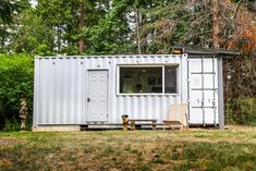 a couple of chairs sitting in front of a white shipping container