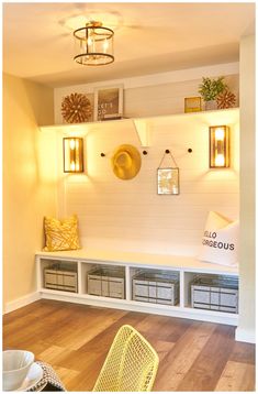 a room with white walls and wooden flooring, some yellow baskets on the wall