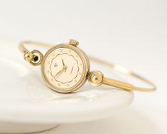 "Vintage lady's watch bracelet made by Uglich Watch Factory, pre-owned timepiece. Watch is in fully working order, professionally serviced, mechanical movement, manual winding, 17 jewels. The tiny bracelet is a ring type, fits for the small wist about 6.4\" (16,5 cm) in circumference. Made in USSR. Year: 1990s The case measures: 0.6\" (1,7 cm) in diameter. Complimentary gift wrapping included. Thanks for checking out my listing, let me know if you have any other questions. Express shipping world Dainty Watches For Women, Tiny Watch, Tiny Bracelet, Watches Women Simple, Ethereal Style, Cocktail Watch, Vintage Gold Watch, Lady Watch, Tiny Jewelry