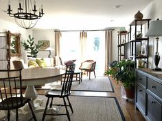 a dining room table and chairs in front of a window