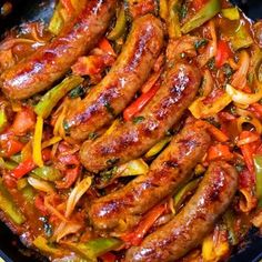 sausages with peppers and onions in a skillet