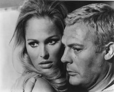 an old black and white photo of a man with blonde hair next to a woman