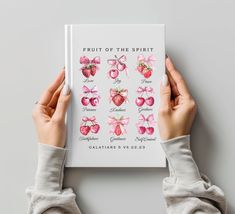 two hands holding up a book with fruit of the spirit