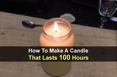 a candle sitting on top of a wooden table next to a glass filled with liquid