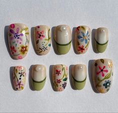 six different sized nails with flowers painted on them