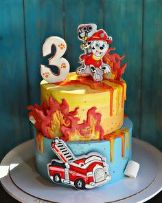 a birthday cake with an image of a firetruck on the front and number 3 on the back