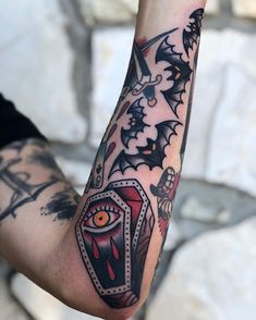 a man's arm with tattoos on it and an evil eye in the middle