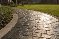 a brick walkway in front of a house