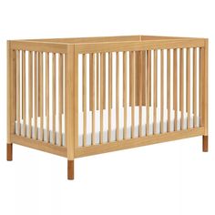 a wooden crib with white sheets on the bottom and side rails, against a white background