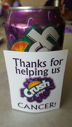 a close up of a can of soda on a table with a sign that says thanks for helping us