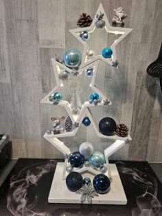 a christmas tree made out of ornaments on a table