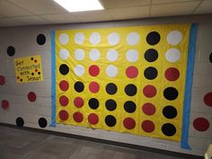 a bulletin board with black, white and red dots on it