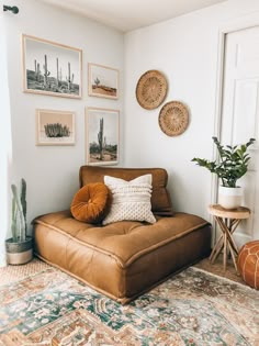 a living room filled with furniture and pictures on the wall