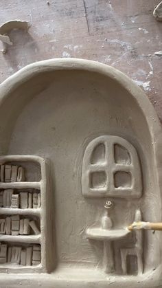 a clay sculpture of a house made to look like an oven