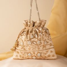 "Beautiful Wedding Indian Katdana Pearl Beaded Bridal Potli Purse Bag | Hand Embroidered Satin Cream Fabric Drawstring Pouch Purse Mobile Bag Package Contents: 1 Size: 10\" x 8\" Designed with the heart, this beautiful Potli or batawa bag are eye catchy and made of premium material. Key Features: Embroidery art work.  This potli is good match with both Indian and western outfits and are superb for wedding and festive parties. This would be best complement to your designer saree, lenhga or any other kind of dress. This is the combination of traditional and modern embroidery work. This is enough to keep your accessories and all needed essentials and it can be a best gift for any woman." Embellished Pouch Bag For Reception, Festive Bag With Pearl Embroidery For Reception, Embroidered Pouch For Reception, Bollywood Style Bags With Handwork For Reception, Bollywood Style Potli Bag For Reception, Bollywood Style Handwork Bags For Reception, Embellished Potli Bag For Gift, Festive Embellished Potli Bag As Gift, Traditional Gold Clutch With Pearl Embroidery