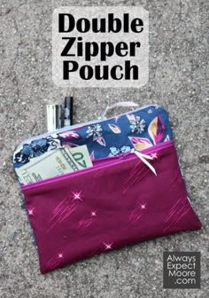 a purple zipper pouch sitting on top of a sidewalk