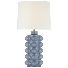 a blue lamp with a white shade on it's base and a light bulb in the middle