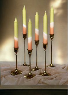 five candles are lined up on a table