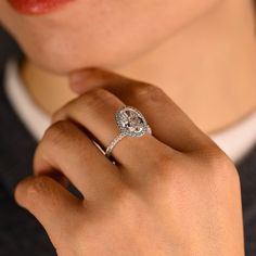 a woman's hand with a diamond ring on it