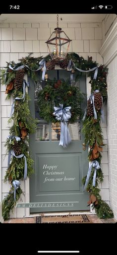 a door decorated with christmas wreaths and pine cones