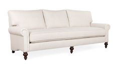 a white couch sitting on top of a wooden frame