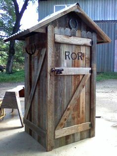 a wooden outhouse with the door open