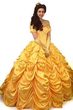 a woman in a yellow dress is posing for the camera