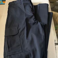 Navy Blue Cargo Pants New Mid-rise Blue Cargo Pants With Pockets, Blue Jeans With Hip Pockets For Work, Blue Mid-rise Cargo Pants With Pockets, Blue Tapered Leg Pants With Side Pockets, Navy Bottoms With Side Pockets For Work, Blue Tapered Leg Cargo Pants With Pockets, Blue Tapered Leg Cargo Pants, Navy Straight Leg Cargo Pants, Blue Utility Cargo Pants