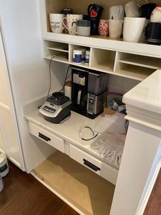 an organized pantry with coffee maker, cups and other items on the shelf above it