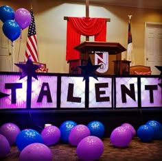 balloons and streamers surround the letters that spell out talent