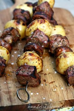 grilled steak, potato and mushroom kabobs on a wooden cutting board with text overlay