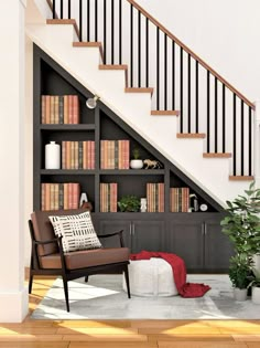 a living room filled with furniture and bookshelves next to a stair case full of books