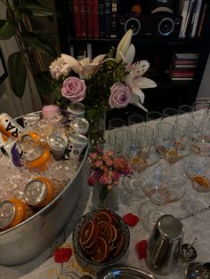 the table is full of glasses, silverware, and other items that are on display