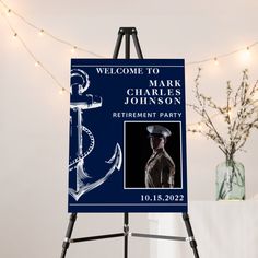 a welcome sign to mark charles johnson retirement party on a easel with lights in the background